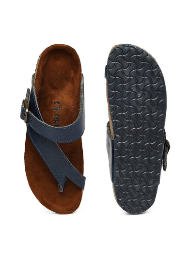 Brown sandal with blue strap and textured black sole on a white background