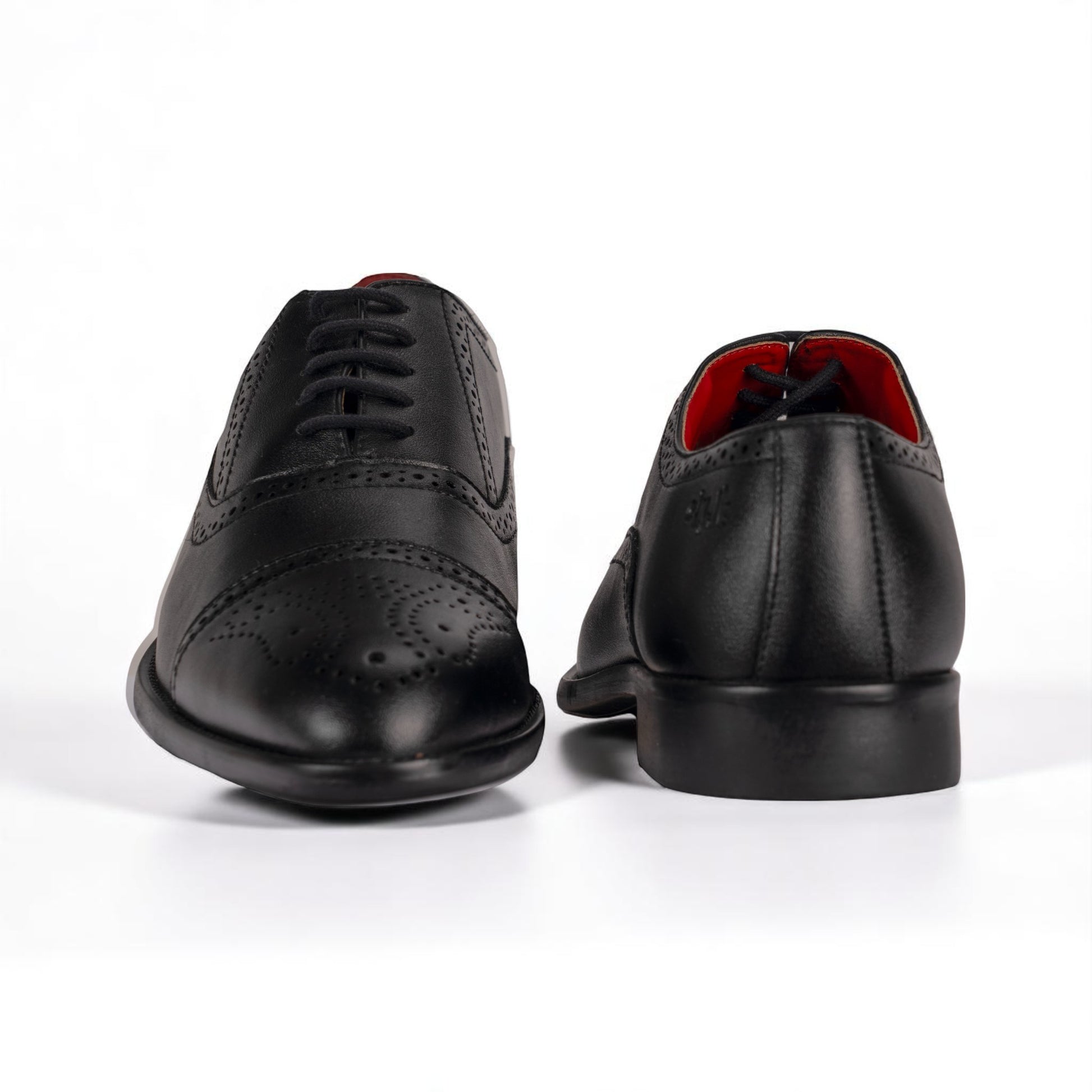 Black leather dress shoes on a white background
