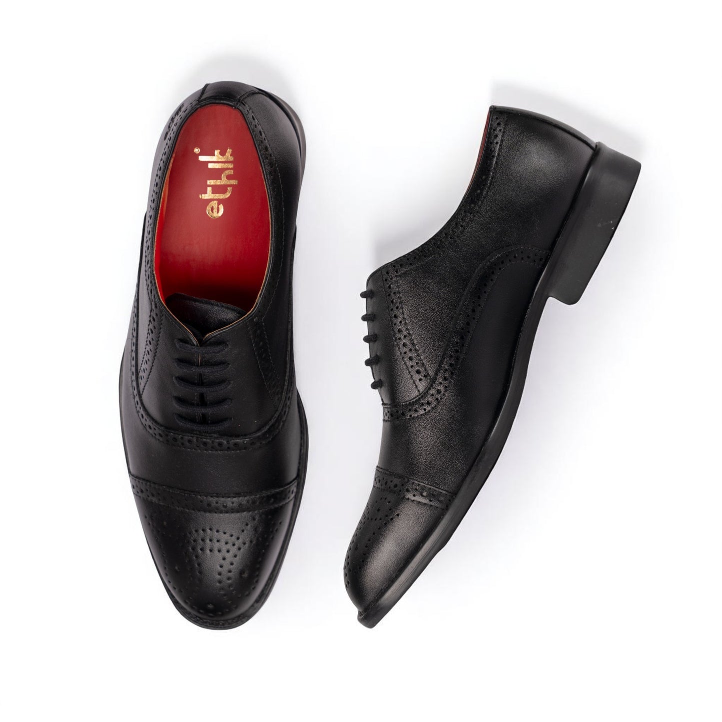 Black dress shoes with red lining on a white background