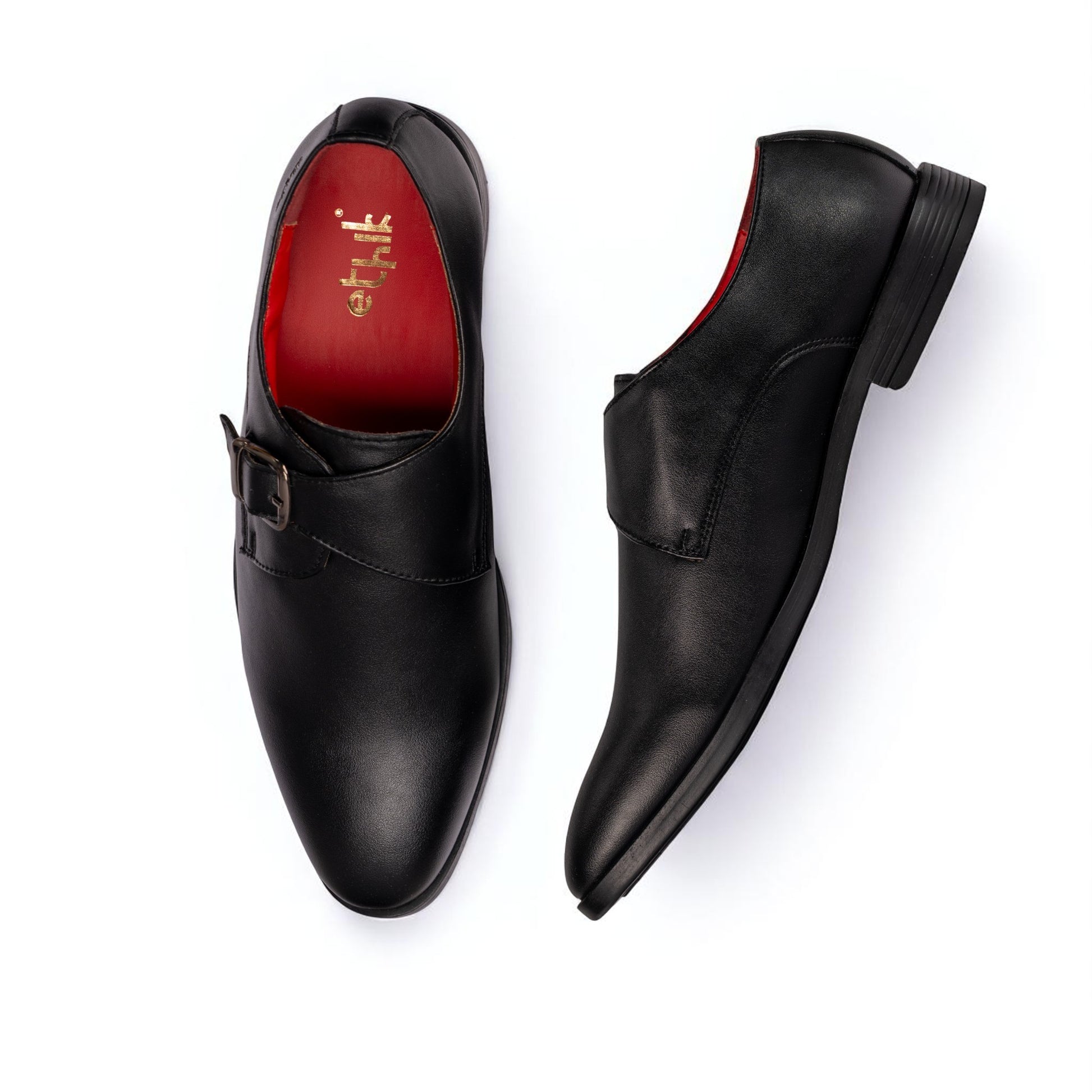 Black dress shoes with a red sole on a white background