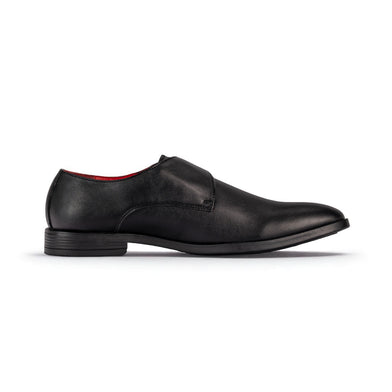 Black leather dress shoe on a white background