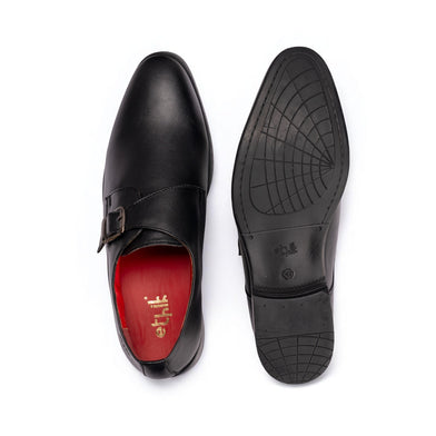 Black leather dress shoe with red lining on a white background