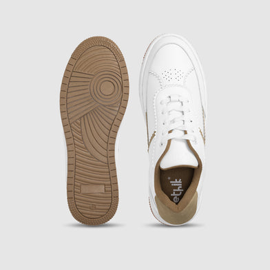 White sneaker with brown sole on a light gray background