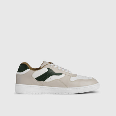 Sneaker with green and brown accents on a light gray background