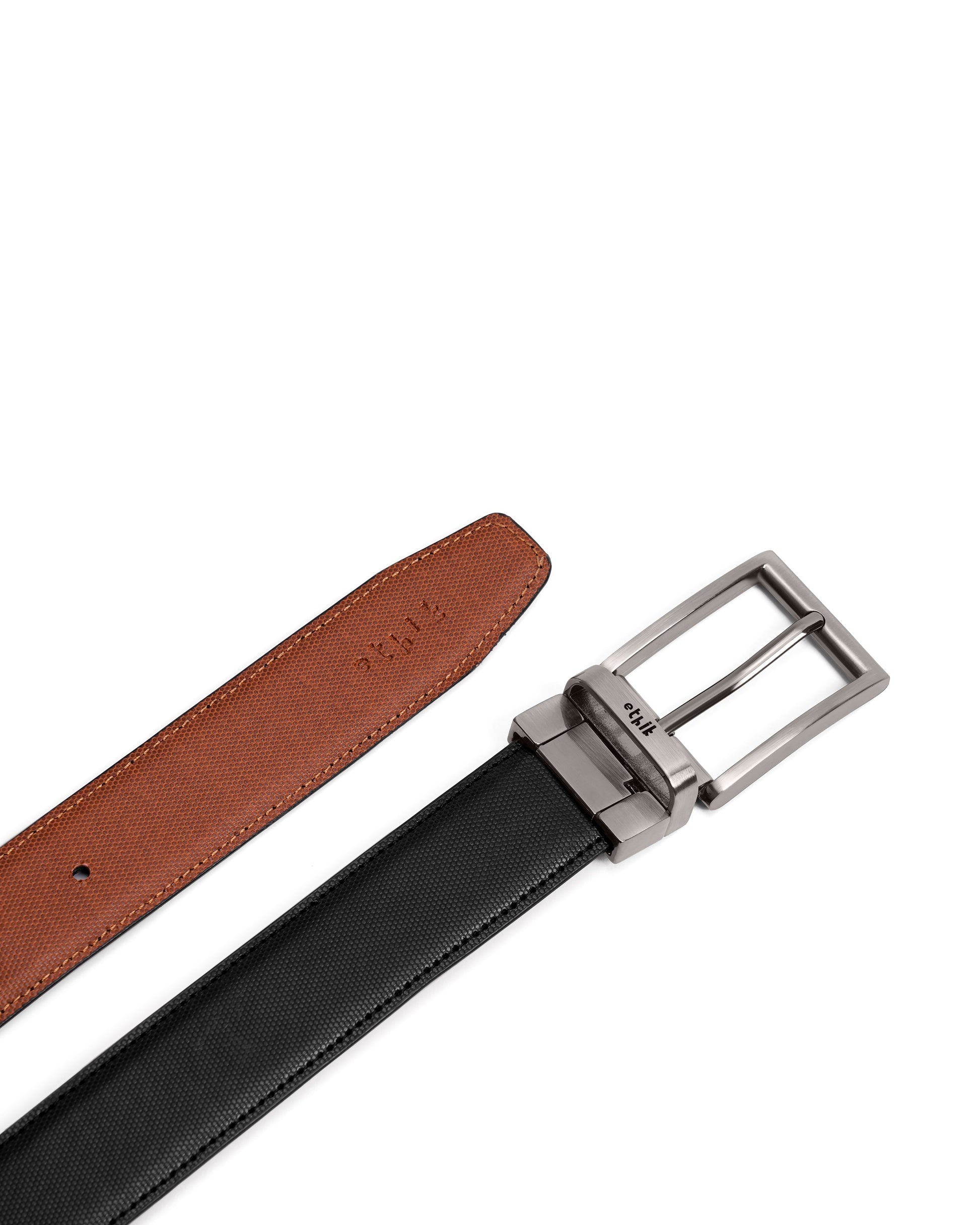 Black belt with brown strap and silver buckle on a white background