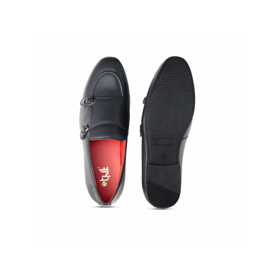 Black loafers with a red interior on a white background