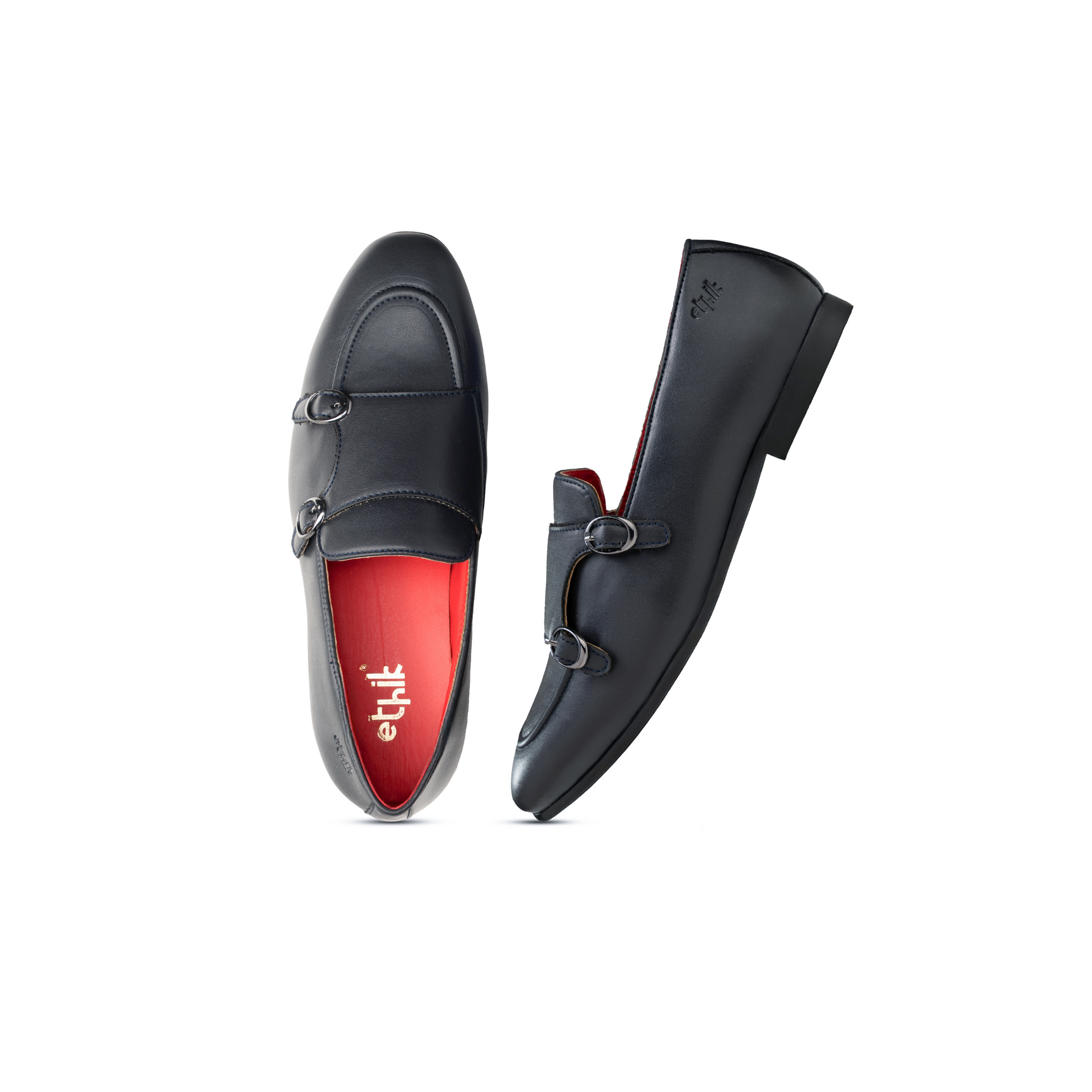 Black loafers with red lining on a white background