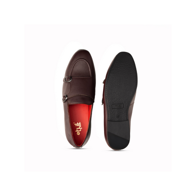 Brown loafers with a red insole on a white background