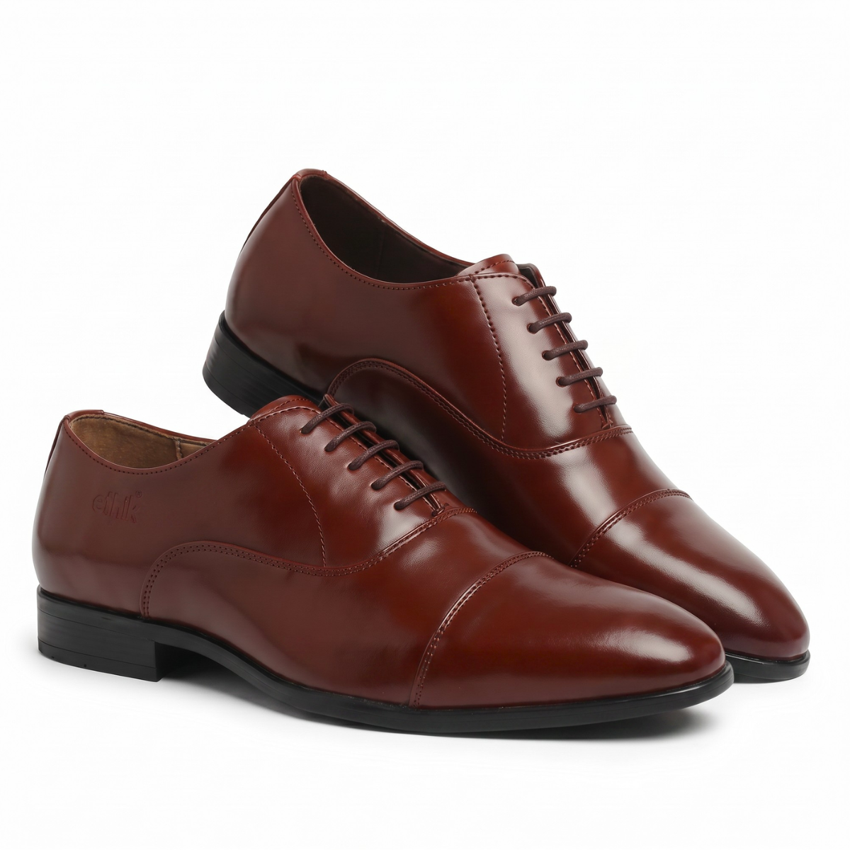 Pair of brown leather dress shoes on a white background