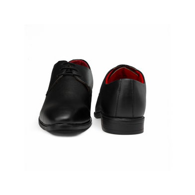 Black leather shoes with red lining on a white background