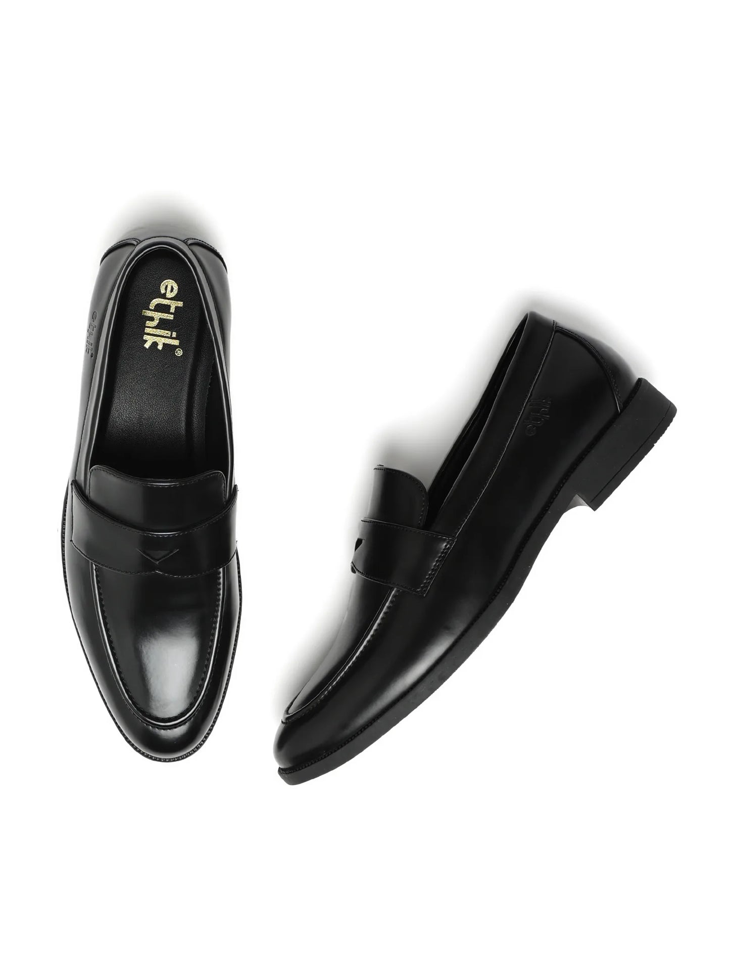 Pair of black loafers on a white background