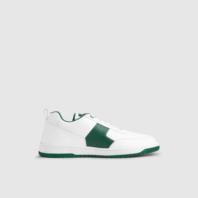 White and green sneaker on a light gray background