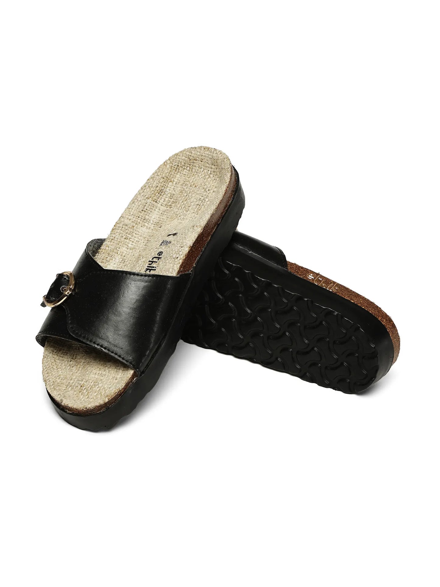 Black slide sandals with cork insole on a white background