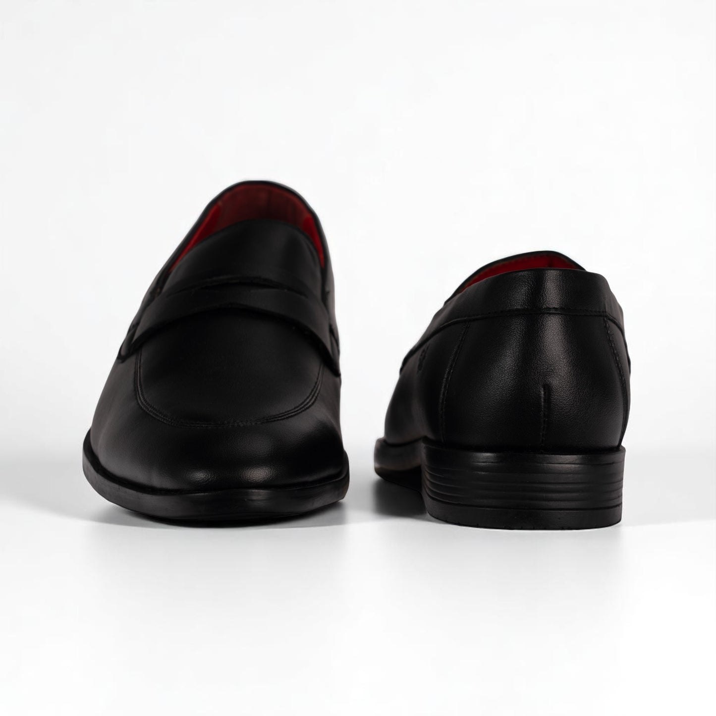 Black leather loafers on a white background