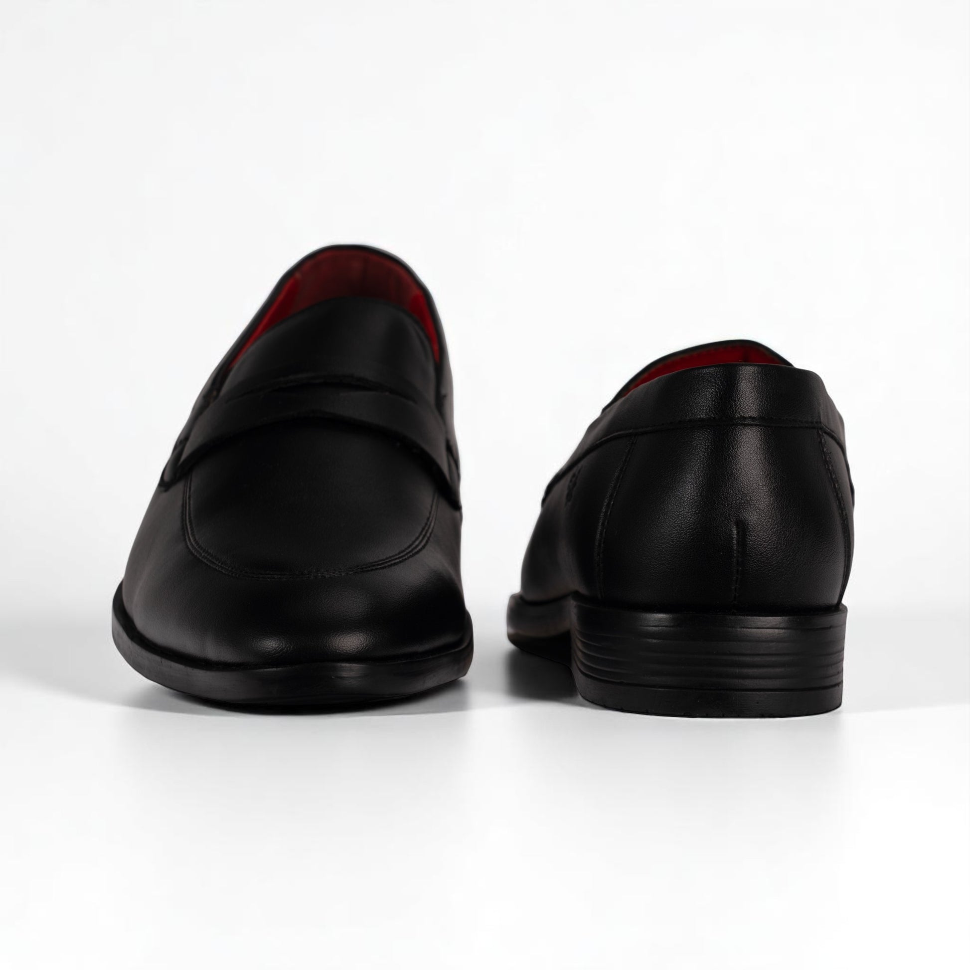 Black leather loafers on a white background