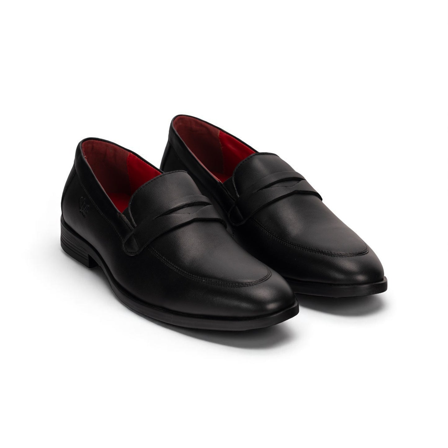 Pair of black loafers with red lining on a white background
