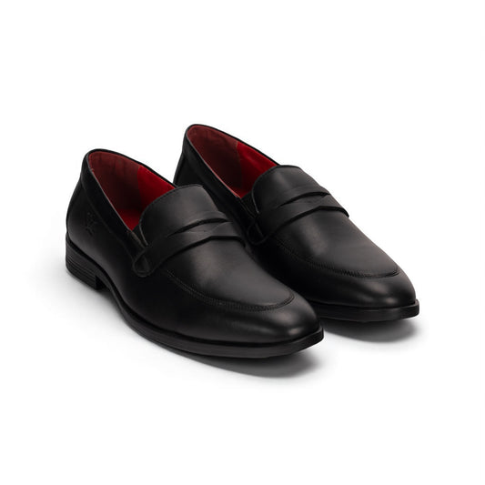 Pair of black loafers with red lining on a white background