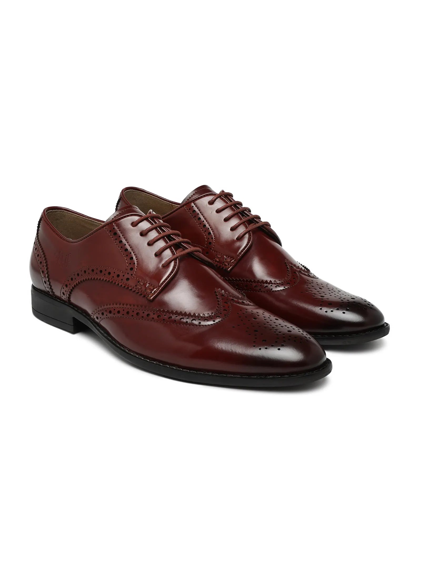 Pair of brown leather dress shoes on a white background