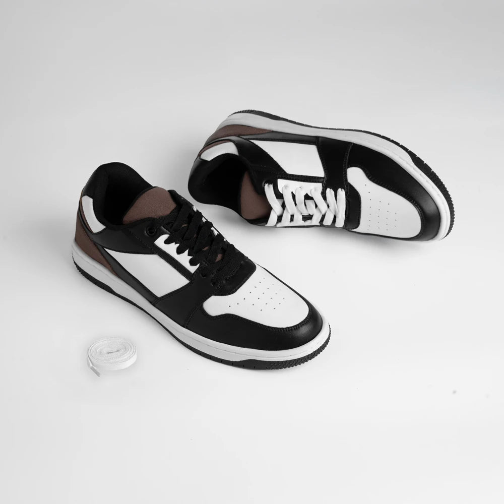 Black and white sneakers with a brand logo on a light gray background