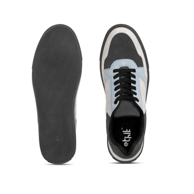 Black and white sneaker with visible brand logo on a white background