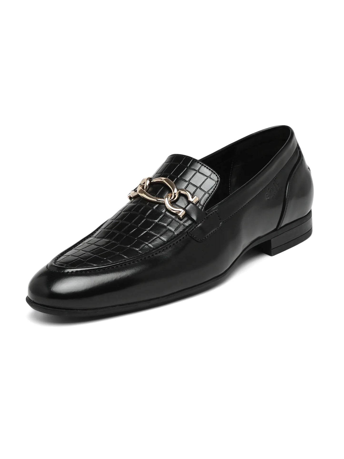 Black leather loafer with crocodile texture and gold buckle on a white background