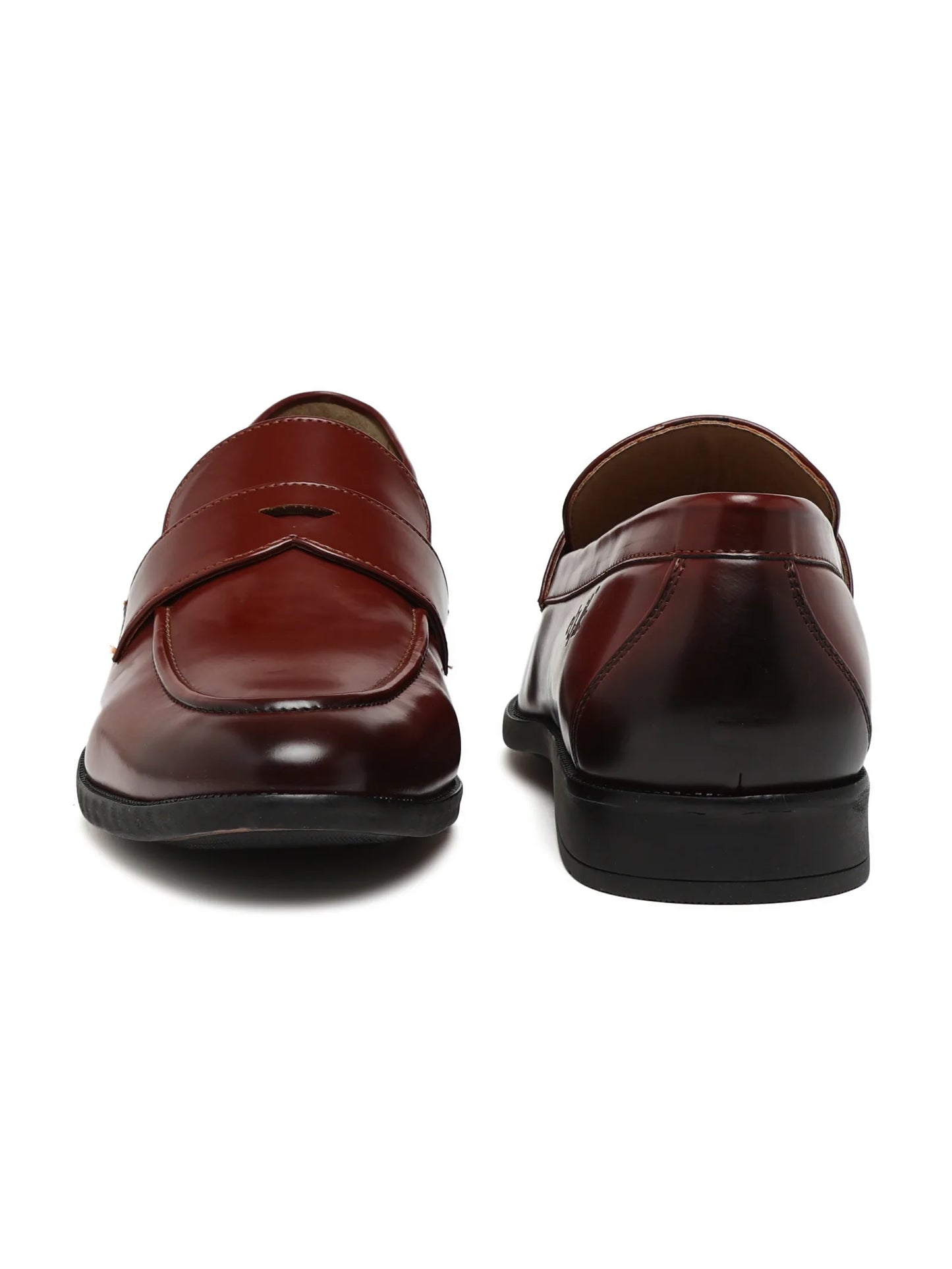 Pair of brown leather loafers on a white background
