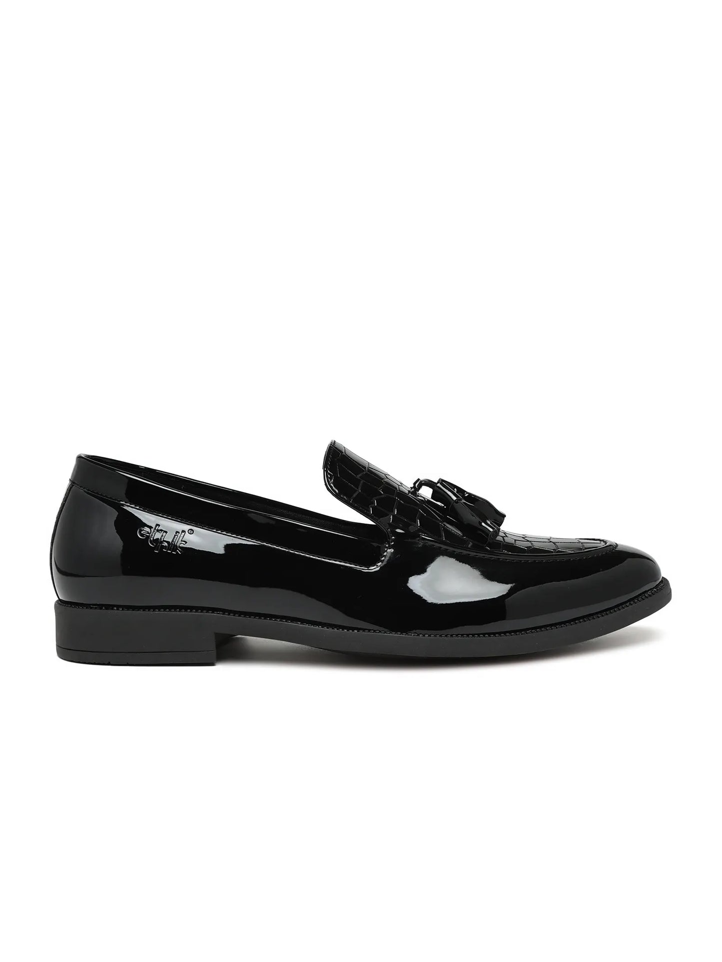 Black patent leather loafer on a white background
