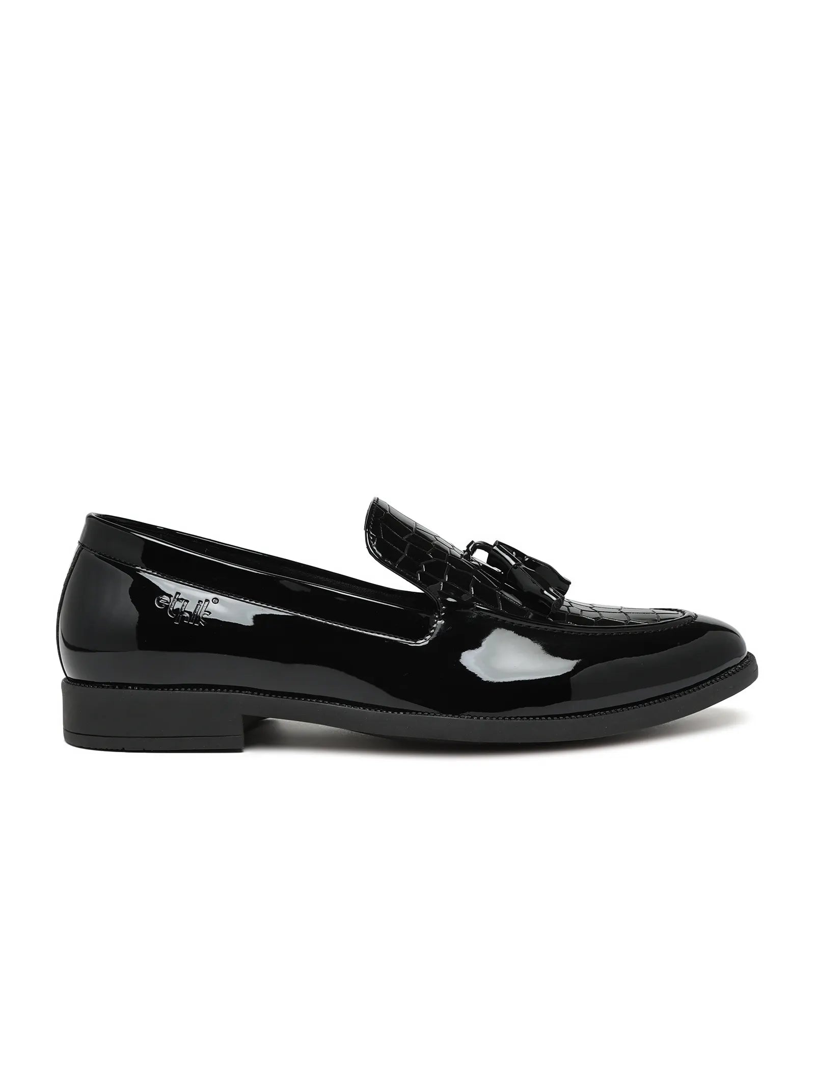 Black patent leather loafer on a white background