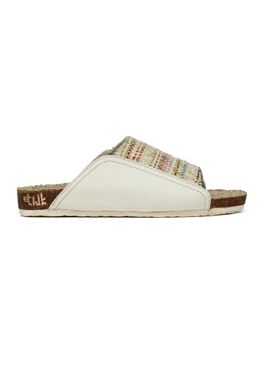 Single sandal with patterned top and white sole on a white background