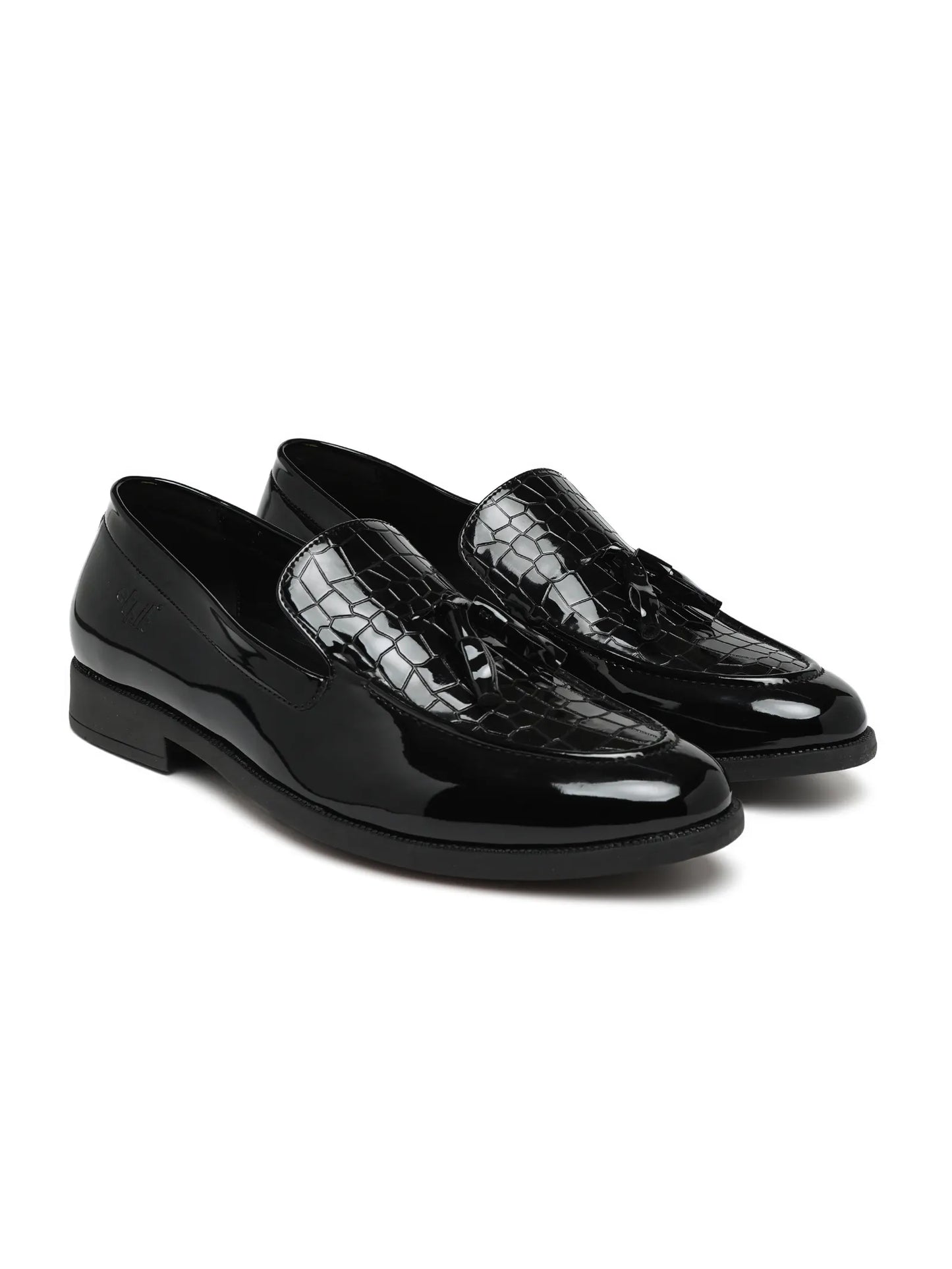 Pair of black patent leather shoes with crocodile texture on a white background