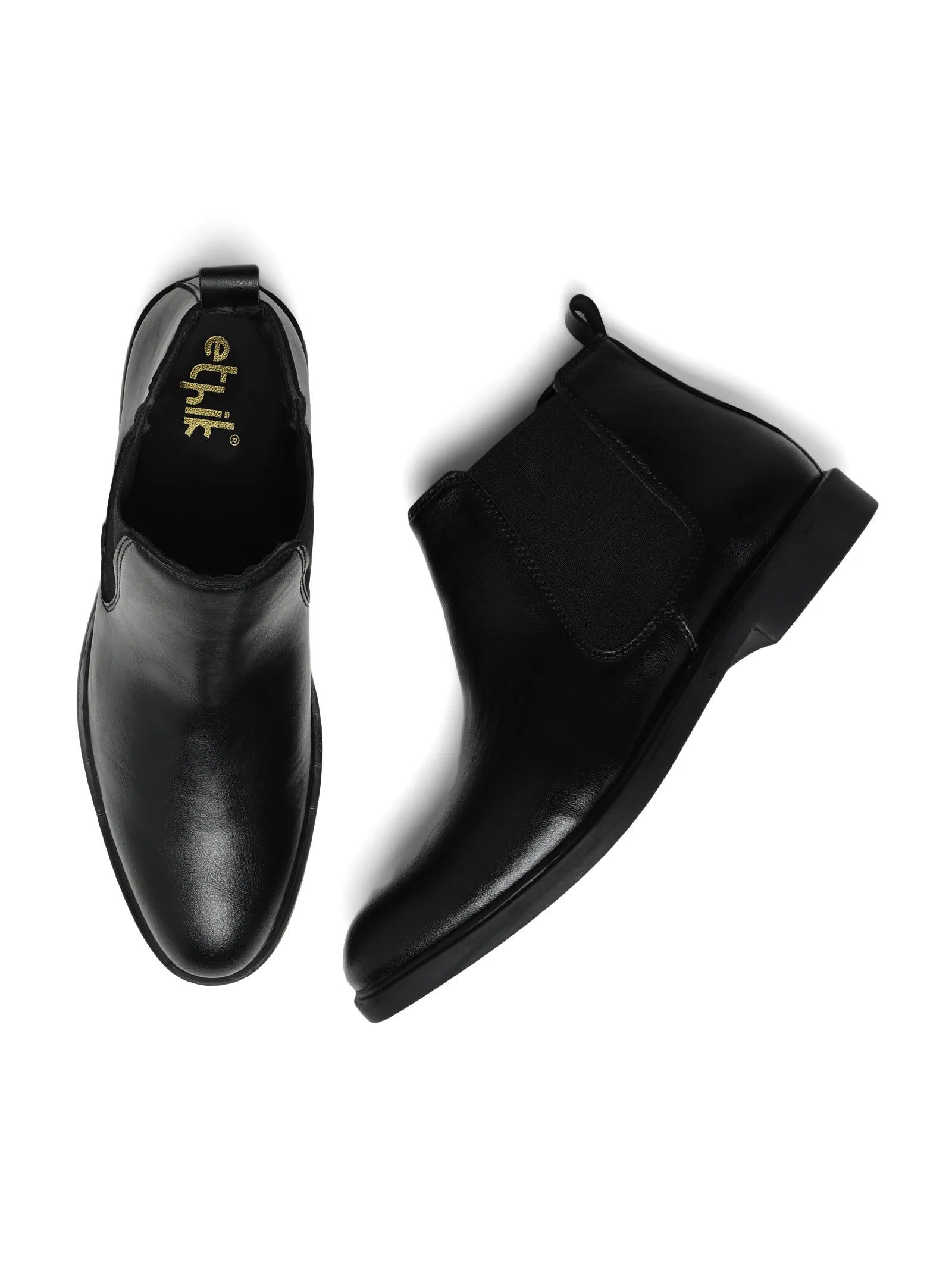 Pair of black leather boots with 'ethik' branding on a white background