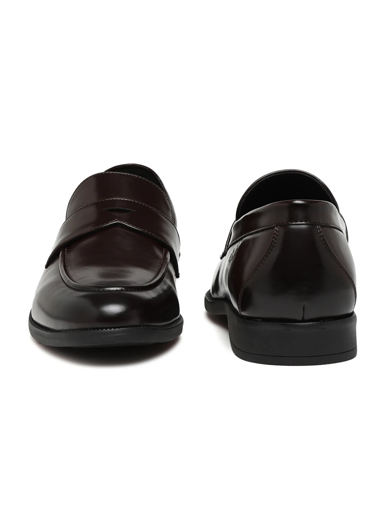 Pair of black loafers on a white background