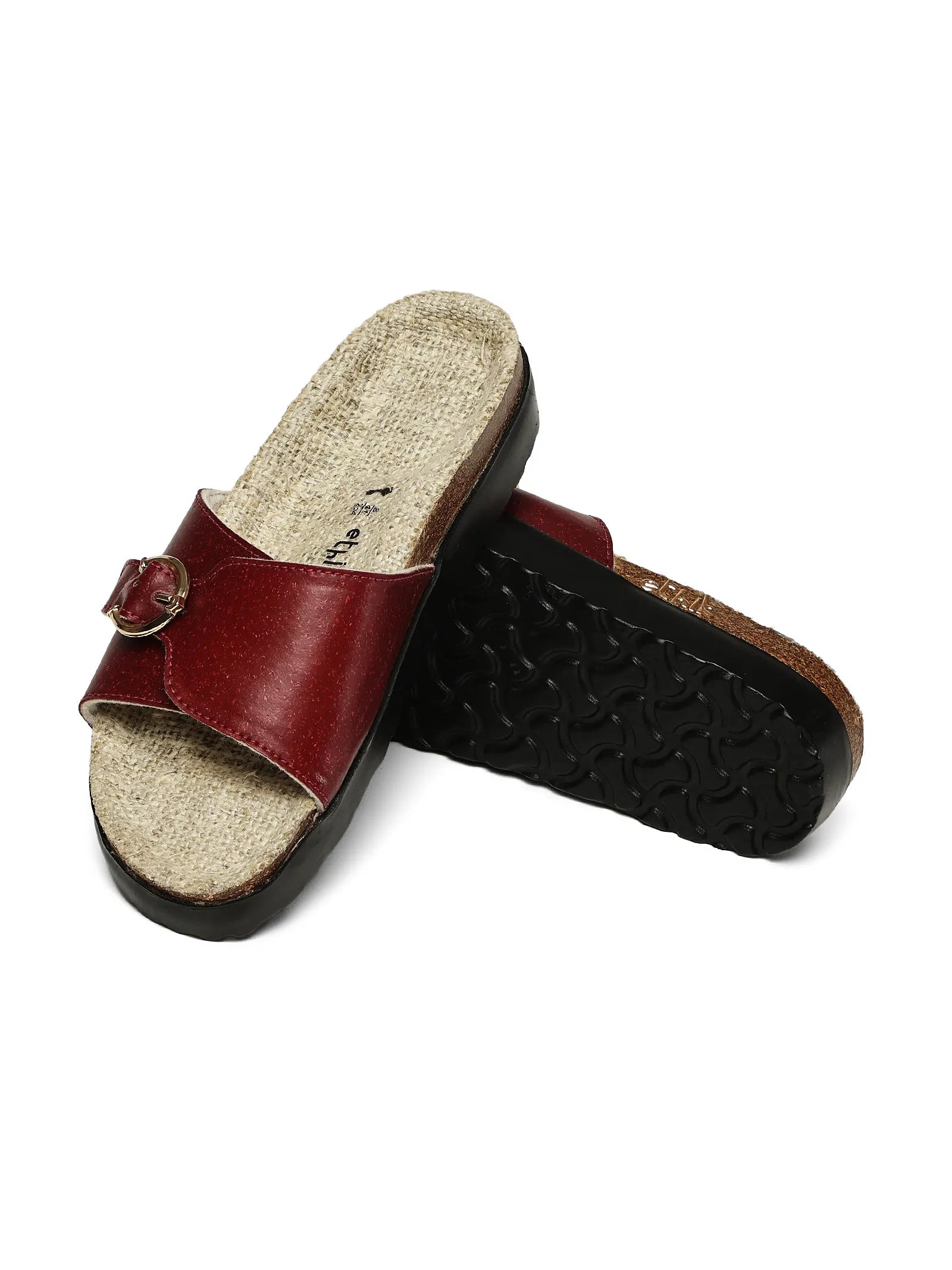 Pair of red sandals with cork sole on a white background
