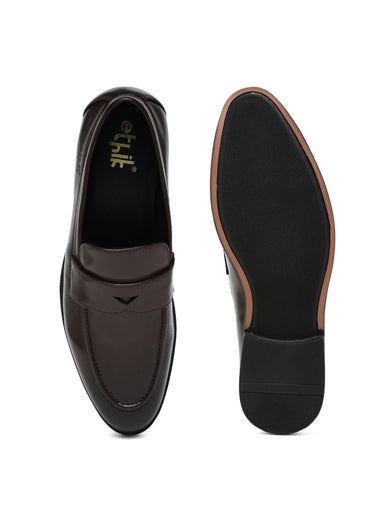Black loafers with brown soles on a white background