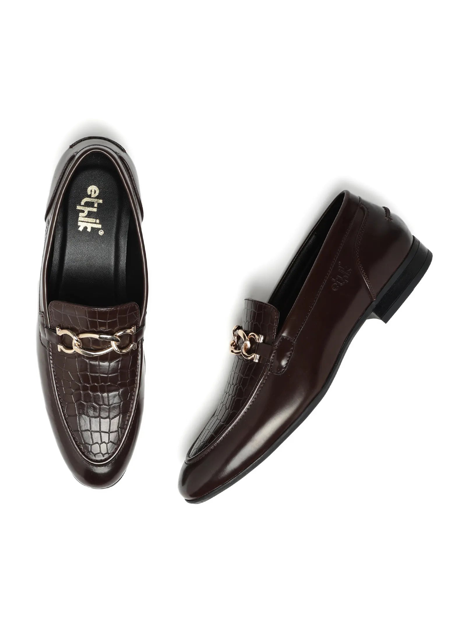 Pair of brown loafers with decorative elements on a white background