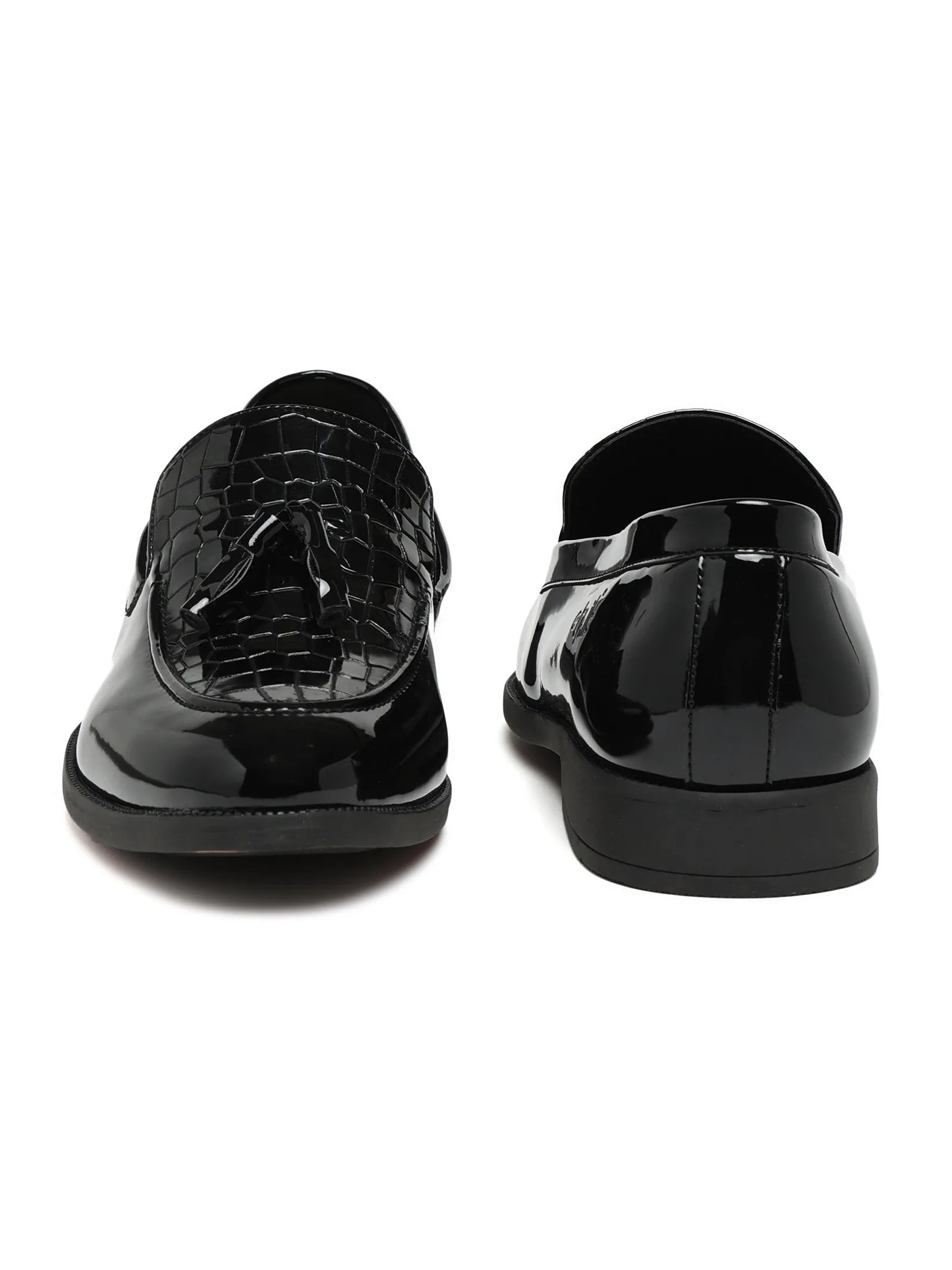 Black patent leather shoes on a white background