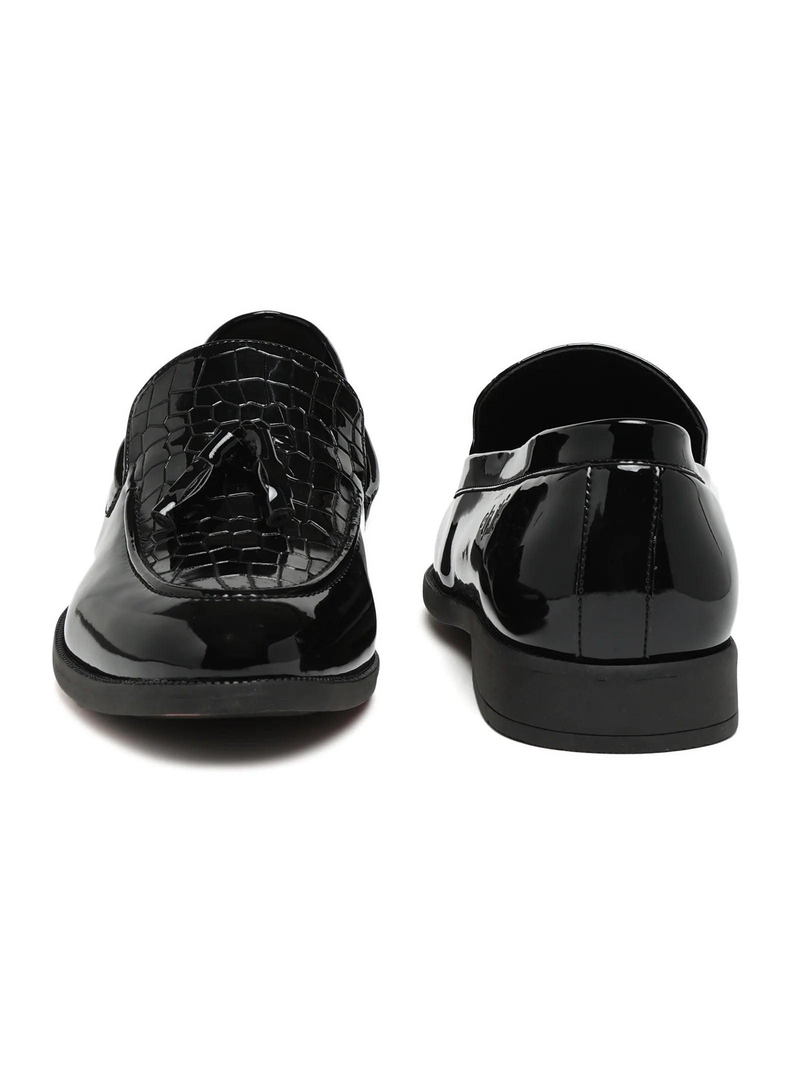 Black patent leather shoes on a white background
