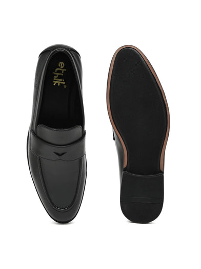 Black loafers with 'etik' branding on a white background