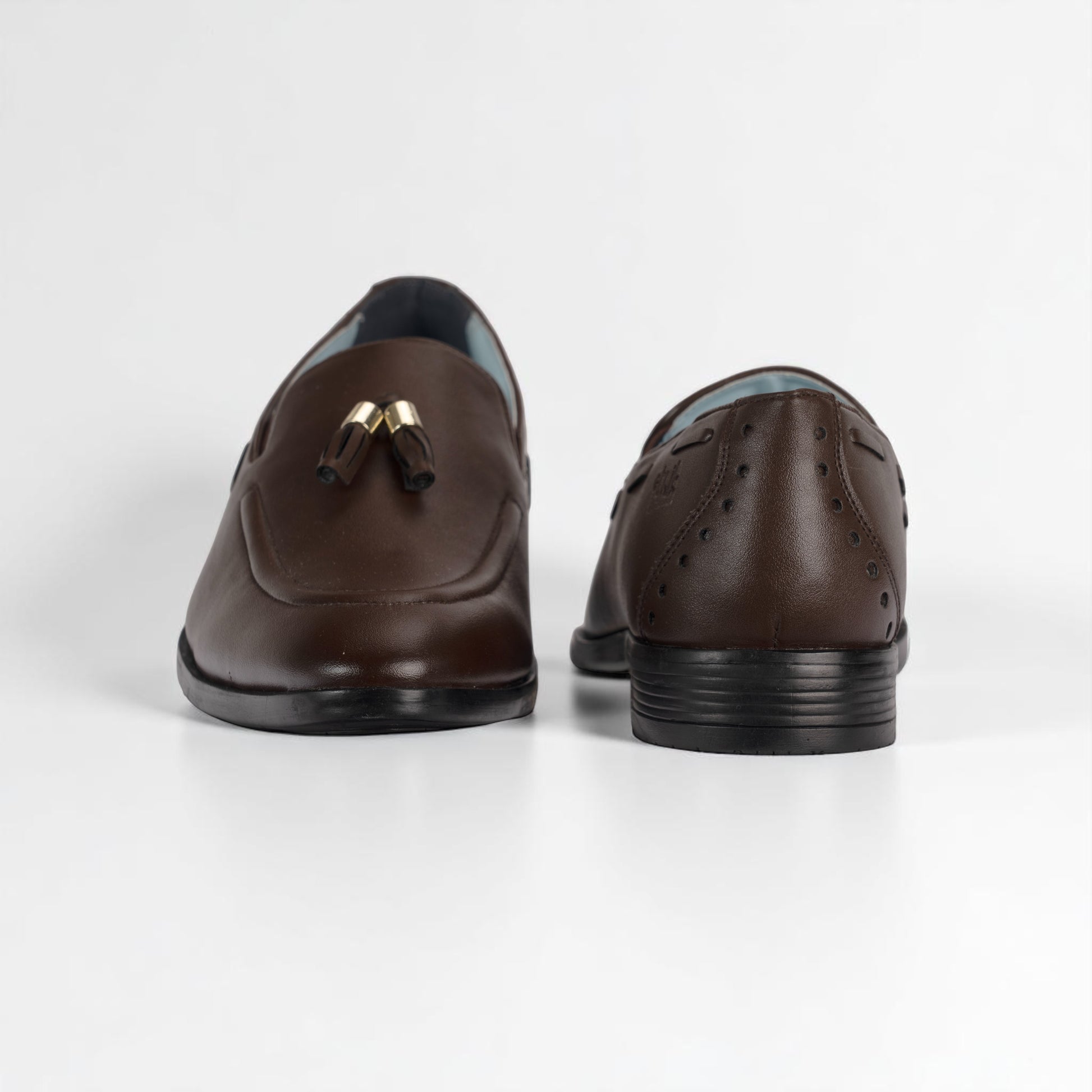Pair of brown leather loafers on a white background