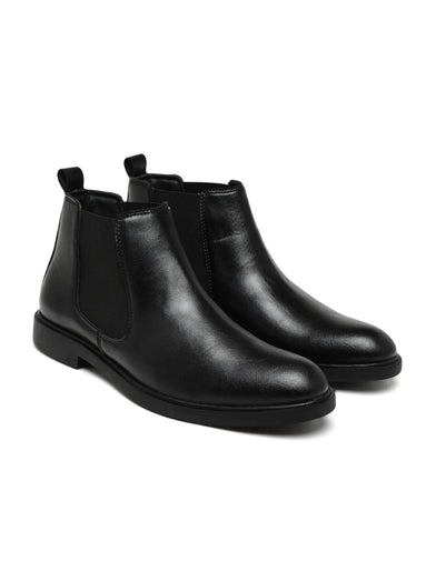 Pair of black leather Chelsea boots on a white background