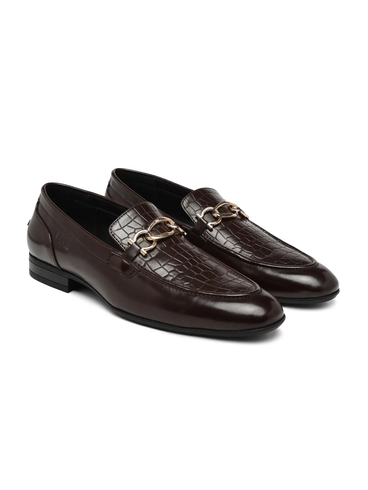 Pair of brown leather loafers with gold accents on a white background