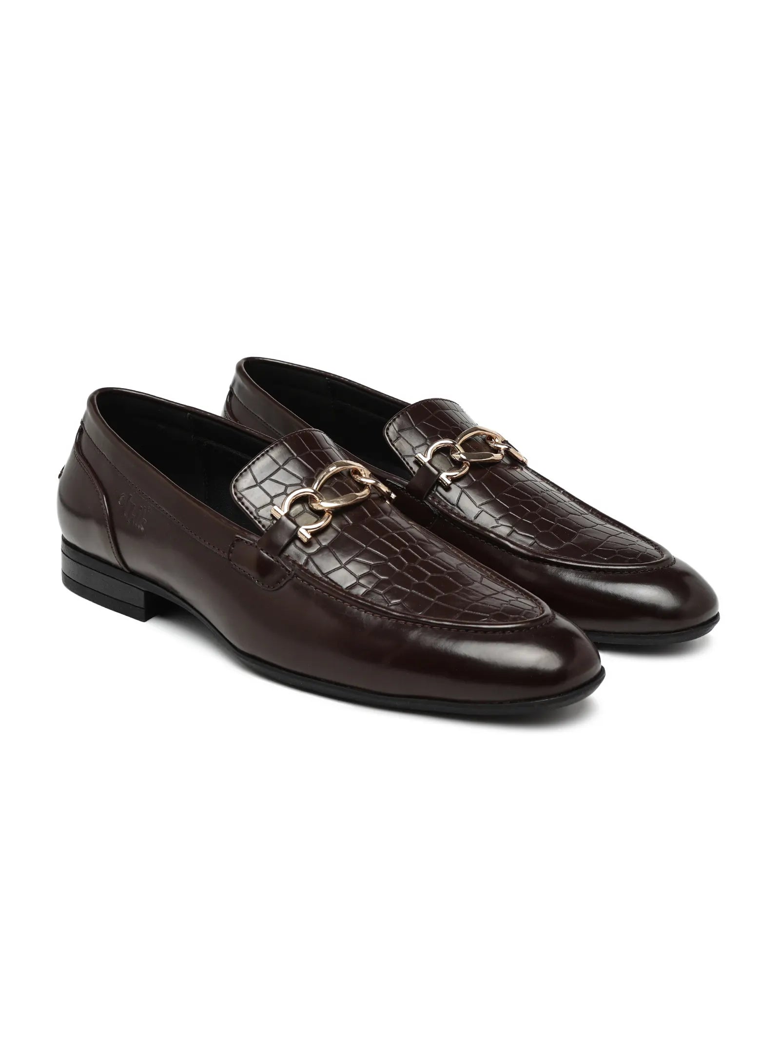 Pair of brown leather loafers with gold accents on a white background